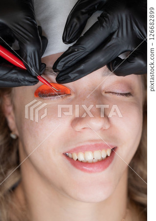 Caucasian woman undergoing eyelash lamination procedure.  126682899
