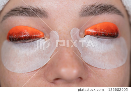 Caucasian woman undergoing eyelash lamination procedure. top view. Caucasian woman undergoing eyelash lamination procedure. top view. 126682905