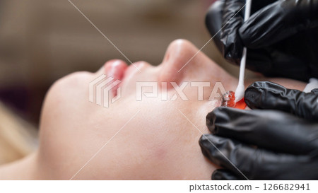 Caucasian woman undergoing eyelash lamination procedure. Caucasian woman undergoing eyelash lamination procedure. 126682941
