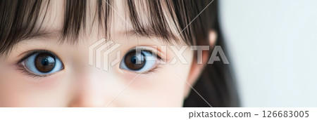 Close up view of a child's eyes highlighting the intricate details of the iris, pupil, and surrounding skin, emphasizing the beauty and clarity of young vision 126683005