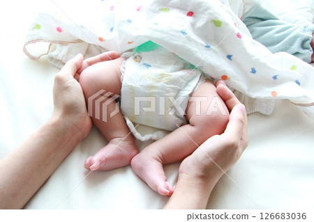 Baby's tiny feet and mom's hands 126683036
