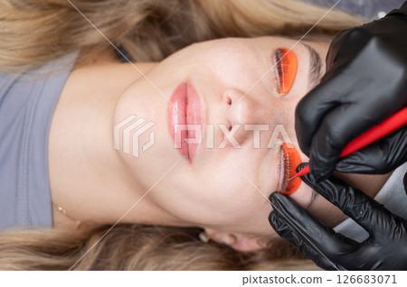 Caucasian woman undergoing eyelash lamination procedure. Caucasian woman undergoing eyelash lamination procedure. 126683071