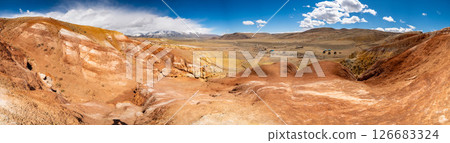 Panoramic view of red and yellow mountains with canyons and gorges at Mars Altai Russia. Popular tourist destination showcasing unique colorful geological formations. Panoramic view of red and yellow mountains with canyons and gorges at Mars Altai Russia. Popular tourist destination showcasing unique colorful geological formations. 126683324