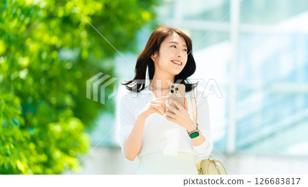 Woman/businesswoman using smartphone outdoors Woman/businesswoman using smartphone outdoors 126683817
