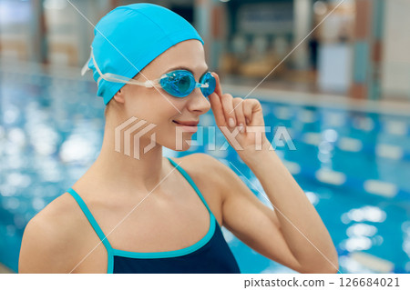 Waist up of young caucasian woman in swimwear in the pool 126684021