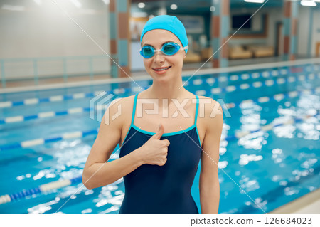 Waist up of young caucasian woman in swimwear in the pool 126684023