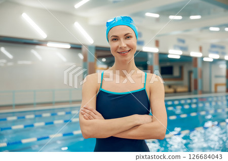 Pretty caucasian young woman in swimming cap and swimsuit Pretty caucasian young woman in swimming cap and swimsuit 126684043