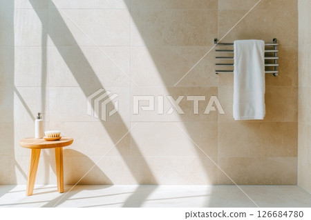 Bright modern bathroom with heated towel rail and natural sunlight illuminating the space 126684780