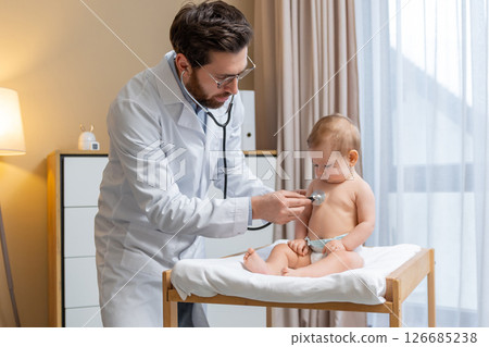 Doctor holding a stethoscope and listening to the babys heartbeat 126685238