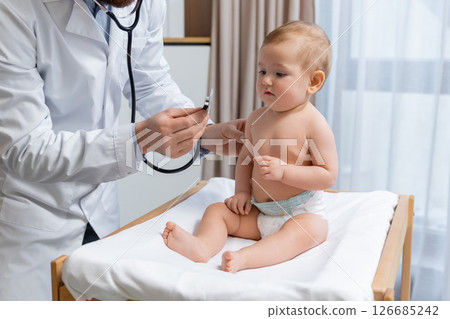 Cute little baby boy having an exam at the doctors office Cute little baby boy having an exam at the doctors office 126685242