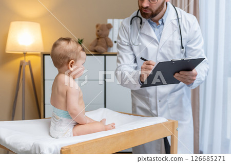 Pediatrician examining a cute little baby boy in his office 126685271