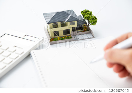 House model, calculator and notebook 126687045
