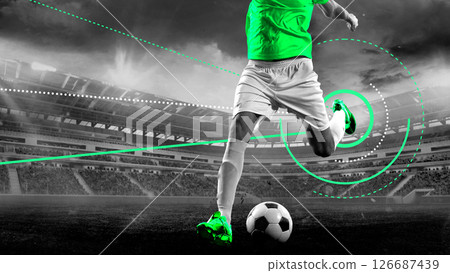 Footballer strikes ball with power under night lights with glowing cyan jersey and sci-fi UI tracking graphic overlays. Modern artwork 126687439