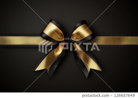Elegant Black and Gold Ribbon Bow on Dark Background for Gift or Decoration Purposes Elegant Black and Gold Ribbon Bow on Dark Background for Gift or Decoration Purposes 126687649