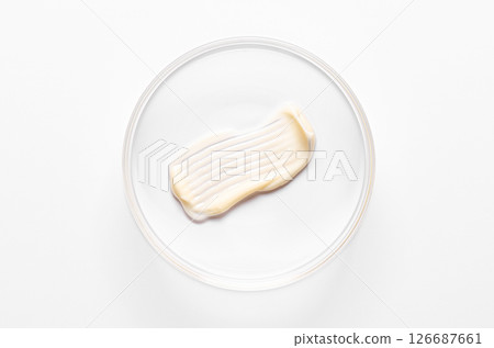 A sample of cosmetic moisturizing or anti-aging cream in a petri dish. A sample of cosmetic moisturizing or anti-aging cream in a petri dish. 126687661