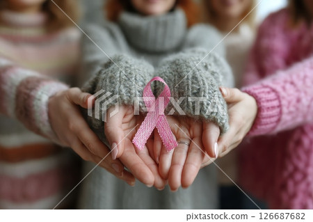 Women United Holding Pink Ribbon for Breast Cancer Awareness in a Circle of Supportive Hands Women United Holding Pink Ribbon for Breast Cancer Awareness in a Circle of Supportive Hands 126687682
