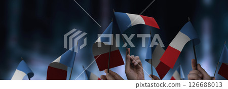 France flags in their hands on a blurred urban background 126688013