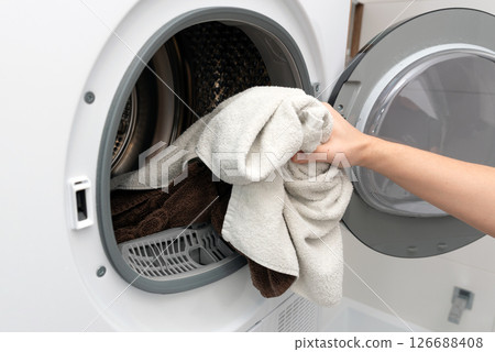 Using washing machine at home, household chores Using washing machine at home, household chores 126688408