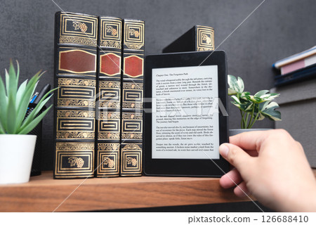 E-book reader device in home library 126688410