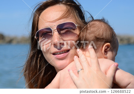 Happy Moment: Mother Holding Baby by the Water 126688522