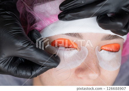 Caucasian woman undergoing eyelash lamination procedure.  126688907