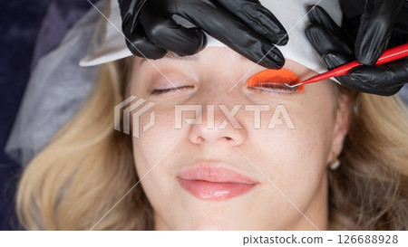 Caucasian woman undergoing eyelash lamination procedure. Caucasian woman undergoing eyelash lamination procedure. 126688928