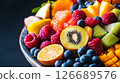 Vibrant Assortment of Fresh Fruits in a Wooden Bowl 126689576