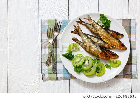 Hot smoked Baltic herrings with kiwi fruit slices Hot smoked Baltic herrings with kiwi fruit slices 126689633