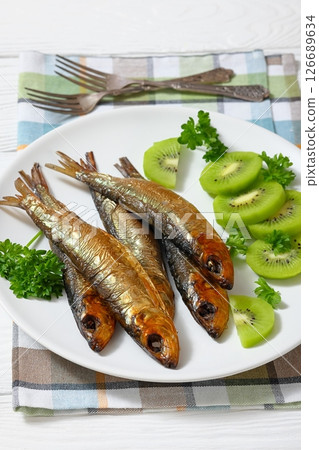 Hot smoked Baltic herrings with kiwi fruit slices Hot smoked Baltic herrings with kiwi fruit slices 126689634