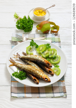 Hot smoked Baltic herrings with kiwi fruit slices Hot smoked Baltic herrings with kiwi fruit slices 126689639