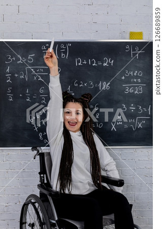 An Empowered Student in a Wheelchair is Joyfully Celebrating Their Success with Math Skills 126689859