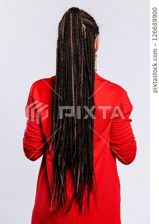 A Stylish and Fashionable Individual with Long Braided Hair Dressed in a Bright Red Outfit A Stylish and Fashionable Individual with Long Braided Hair Dressed in a Bright Red Outfit 126689900