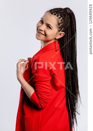 A Confident Young Woman Sporting Braids, Dressed in a Vibrant and Stylish Red Outfit 126689928