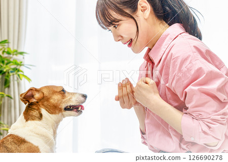 A woman who plays with a dog A woman who plays with a dog 126690278