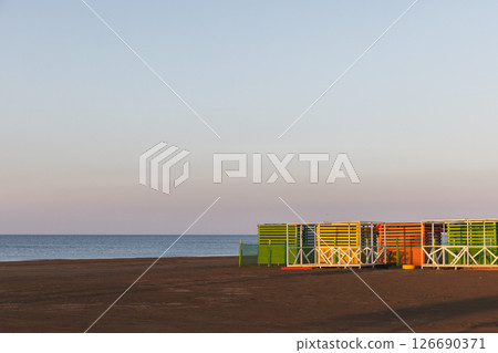 Caspian sea coastal landscape. Brightly painted wooden huts Caspian sea coastal landscape. Brightly painted wooden huts 126690371