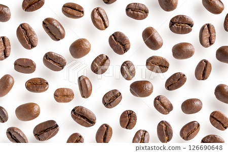 Roasted coffee beans. Scattered coffee beans on a white background with clipping paths. Close up image. Roasted coffee beans. Scattered coffee beans on a white background with clipping paths. Close up image. 126690648