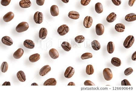 Roasted coffee beans. Scattered coffee beans on a white background with clipping paths. Close up image. Roasted coffee beans. Scattered coffee beans on a white background with clipping paths. Close up image. 126690649