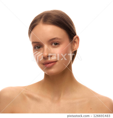 Portrait of beautiful woman with clean natural makeup, flawless skin, smooth hair tied back and subtle smile under white background Portrait of beautiful woman with clean natural makeup, flawless skin, smooth hair tied back and subtle smile under white background 126691483