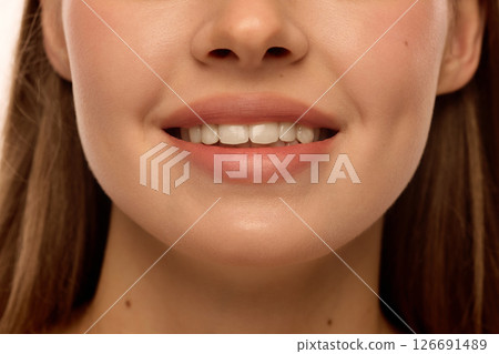 Woman smiling with white teeth, natural pink lips, glowing cheekbones and smooth skin. Female model with natural make-up Woman smiling with white teeth, natural pink lips, glowing cheekbones and smooth skin. Female model with natural make-up 126691489