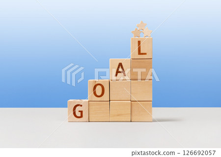Wooden cubes with the words goal and wooden stars are a symbol of success, business progress, strategic development of a company, startup. Business concept Wooden cubes with the words goal and wooden stars are a symbol of success, business progress, strategic development of a company, startup. Business concept 126692057