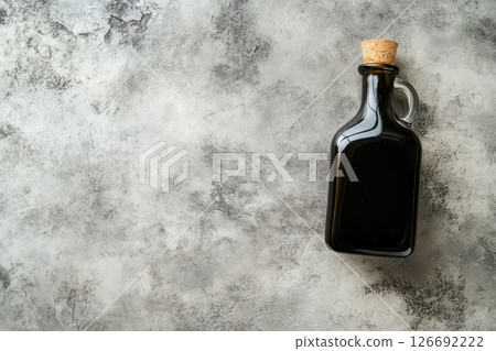 Olive oil bottle on a rustic gray surface Olive oil bottle on a rustic gray surface 126692222