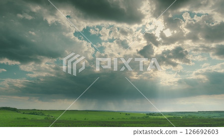 A Dramatic Cloudy Sky Over an Expansive Green Landscape Captivates the Imagination and Heart Time lapse. 126692603