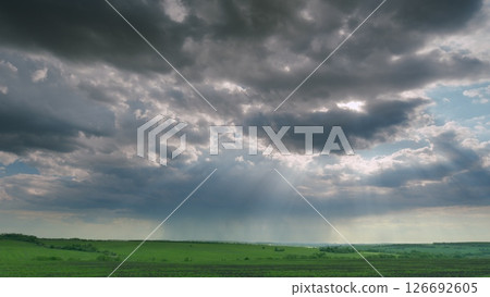 Dramatic Cloud Formation Showcasing a Stunning Vista Over a Lush, Green Landscape Time lapse. Dramatic Cloud Formation Showcasing a Stunning Vista Over a Lush, Green Landscape Time lapse. 126692605