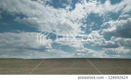 An Expansive Sky and Horizon Stretching over a Bare Field, a Stunning Natural Landscape Time lapse. An Expansive Sky and Horizon Stretching over a Bare Field, a Stunning Natural Landscape Time lapse. 126692624