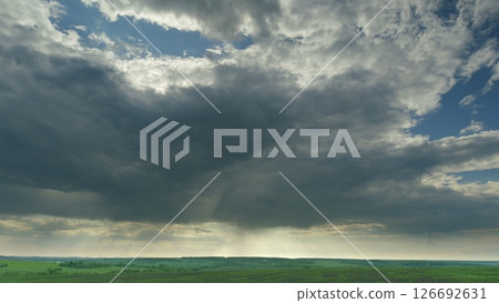 A Dramatic Cloudscape Over a Lush Green Landscape, Capturing Its Enchanting Beauty Time lapse. A Dramatic Cloudscape Over a Lush Green Landscape, Capturing Its Enchanting Beauty Time lapse. 126692631