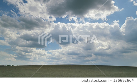 An Expansive, Cloudy Sky Over a Beautifully Serene and Picturesque Landscape Scene Time lapse. An Expansive, Cloudy Sky Over a Beautifully Serene and Picturesque Landscape Scene Time lapse. 126692664
