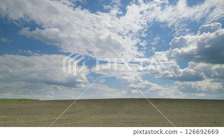 A Stunning Scenic Sky Featuring Dramatic Clouds Stretching Over a Vast Flat Landscape Time lapse. A Stunning Scenic Sky Featuring Dramatic Clouds Stretching Over a Vast Flat Landscape Time lapse. 126692669