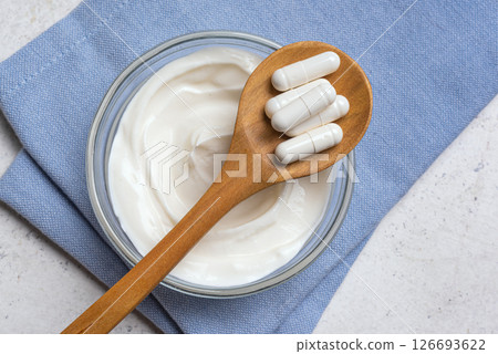 Capsules probiotic and bowl of yogurt 126693622