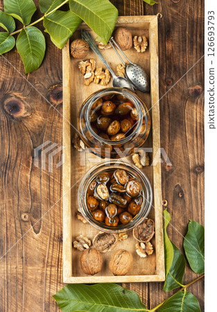 Delicious walnut jam and peeled walnut. Delicious walnut jam and peeled walnut. 126693793
