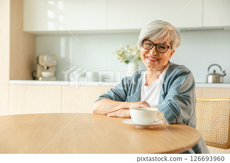 Portrait of confident stylish european middle aged senior woman. Older mature 60s lady smiling at home. Happy attractive senior female looking camera close up face headshot portrait. Happy people Portrait of confident stylish european middle aged senior woman. Older mature 60s lady smiling at home. Happy attractive senior female looking camera close up face headshot portrait. Happy people 126693960